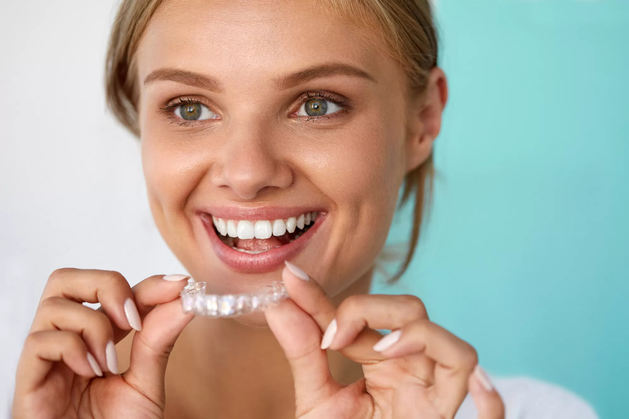 Smiling Woman With Beautiful Smile Using Teeth Whitening Tray. High Resolution Image